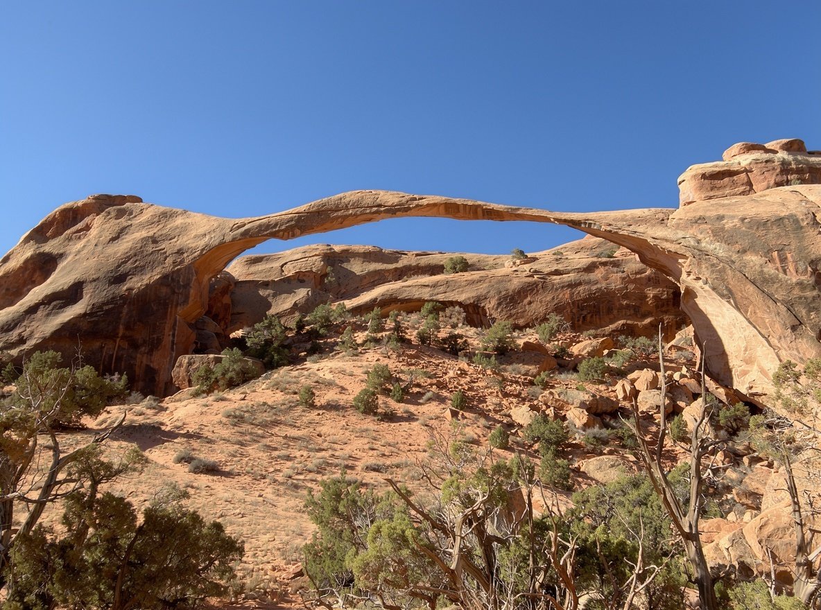 Landscape Arch, a long thin ribbon of sandstone spanning between two rock buttresses