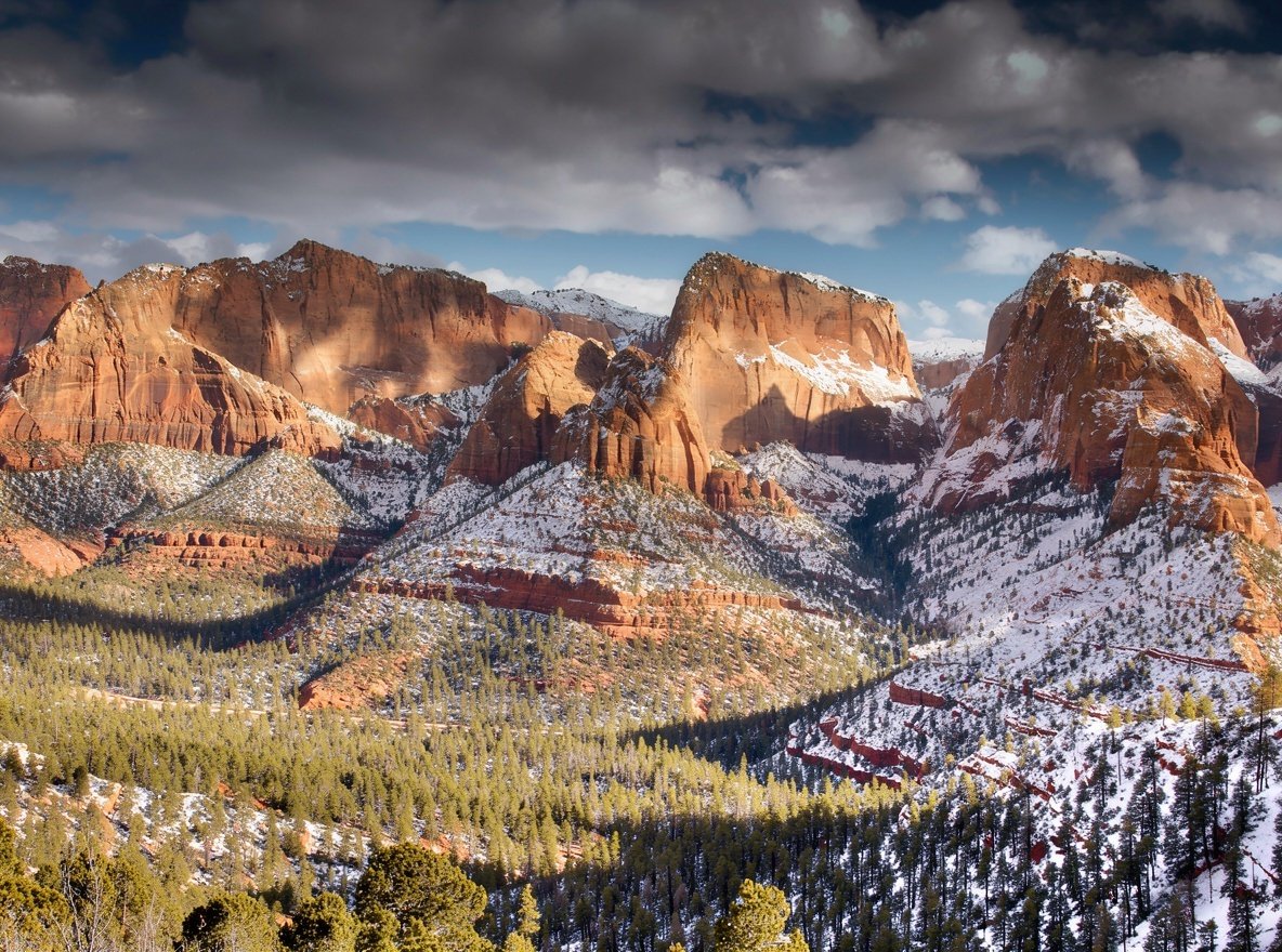 Steep parallel red sandstone finger canyons with snow on the rims in the Kolob Canyons area of Zion