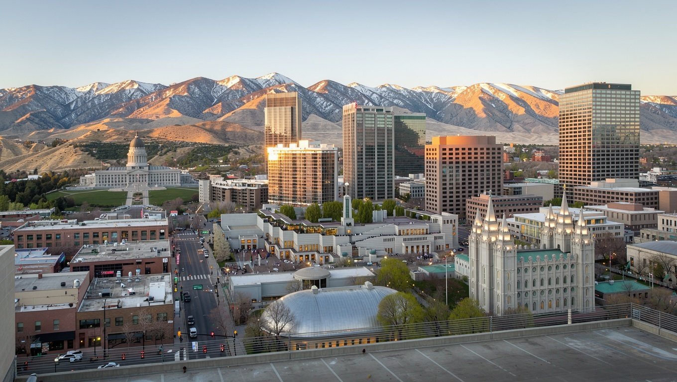 Downtown Salt Lake City skyline with the Wasatch mountains rising behind it at golden hour